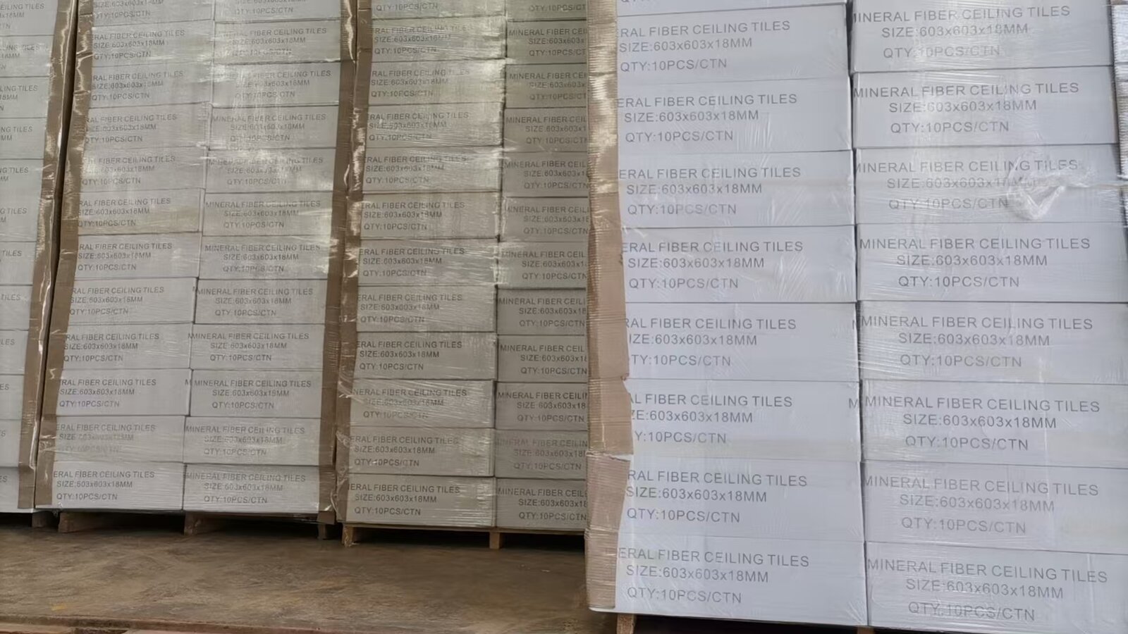 Packed mineral fiber ceiling tile cartons prepared for clean warehouse storage and site delivery